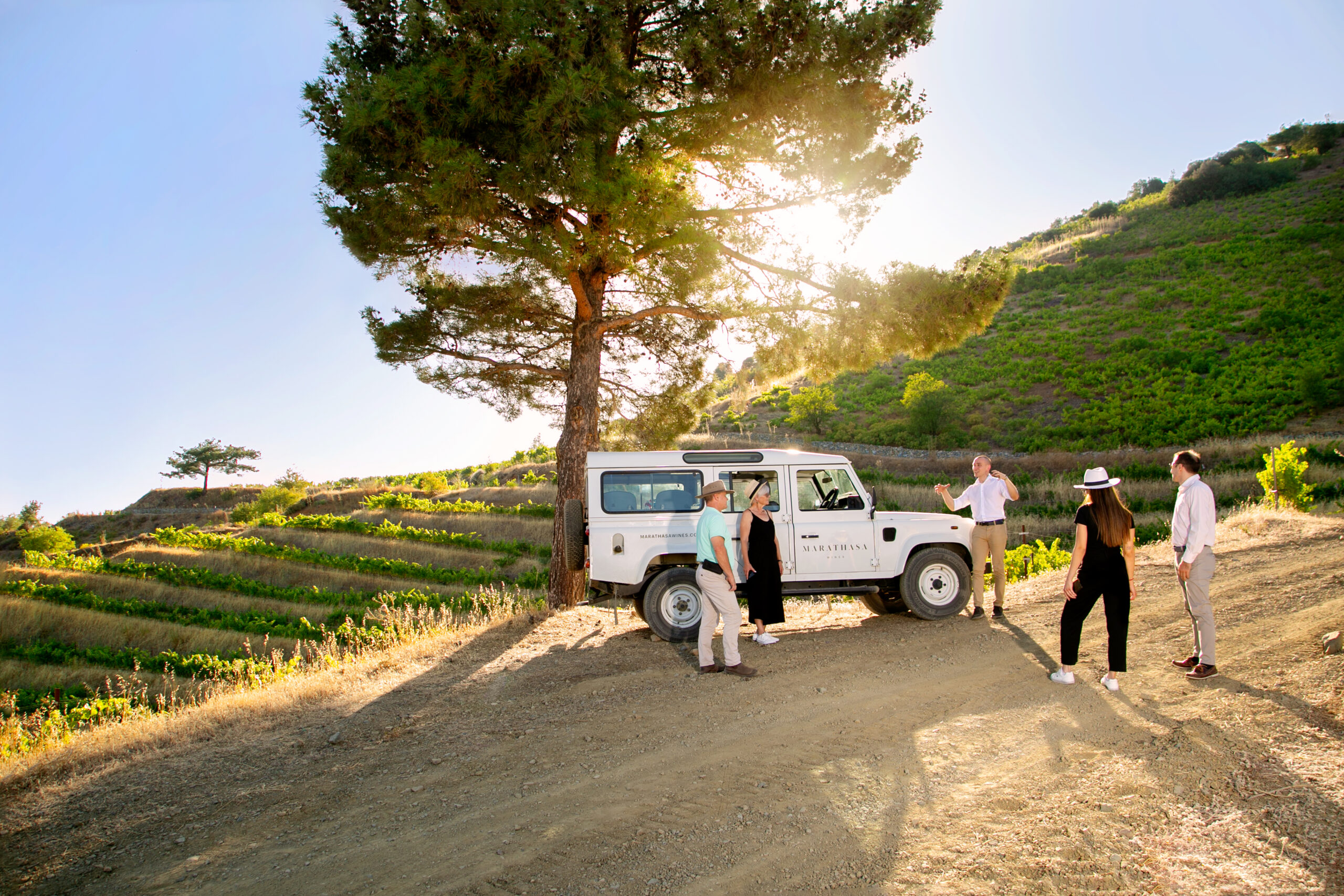 White Landrover and guests in the vineyards